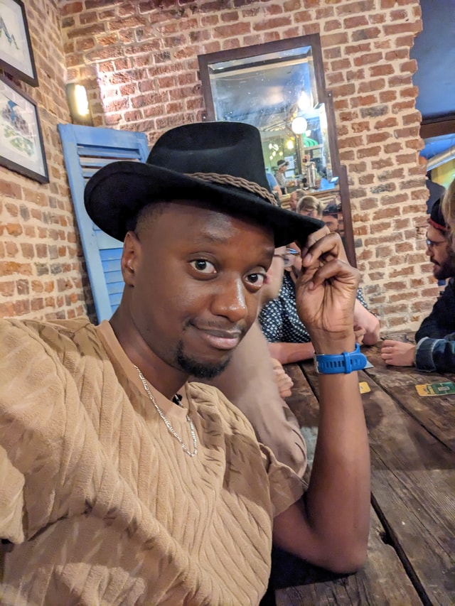 Me smiling because I'm surrounded by my friends.